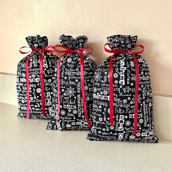 Set of 3 Christmas gift bags 5 1/2 inches x 9 1/2 inches Reusable Eco-Friendly Cotton Fabric presents gifts words white black red ribbon