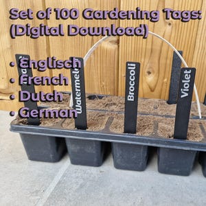 May include: A black plastic seed starting tray with soil and plant markers. The markers are labeled with plant names like "Watermelon," "Broccoli," and "Strawberry." The text "Set of 100 Gardening Tags (Digital Download)" is at the top.