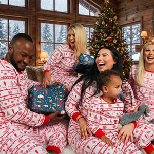 Family celebrating Christmas around the fireplace and exchanging gifts