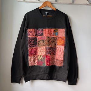 May include: A distressed wooden sign with the words "Welcome to our home" in white. The sign has a rustic finish and a simple design, ideal for a porch or hallway.