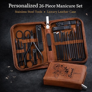 May include: A 26-piece manicure set with stainless steel tools and a luxury leather case. The set includes black nail clippers, scissors, and various grooming tools. The case is brown and includes a smaller, personalized case with the name "Sarah".