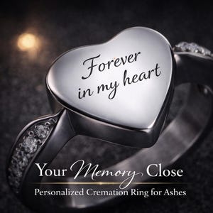 May include: A silver cremation ring with a heart-shaped top. The heart is engraved with "Forever in my heart." The ring band is adorned with small, clear stones. The text "Your Memory Close" and "Personalized Cremation Ring for Ashes" are below the ring.