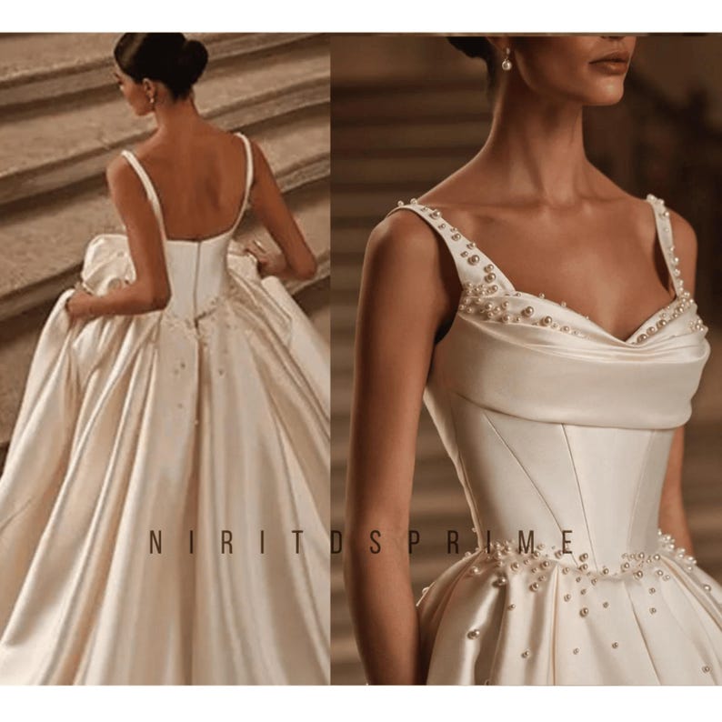 K&ouml;nnte beinhalten: Ein wei&szlig;es Satin-Hochzeitskleid mit einem herzf&ouml;rmigen Ausschnitt und einem taillierten Oberteil. Das Kleid hat einen vollen Rock und ist mit Perlen verziert.