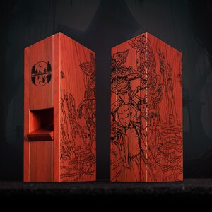 May include: Two red wooden boxes with black etched illustrations. One box features a logo with a moon and trees, the other depicts characters. The boxes are rectangular with a slot on one side.