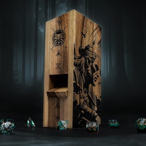 May include: Wooden dice tower featuring etched artwork of a warrior and symbols. The tower is rectangular with a slot for dice to roll through. Several colourful dice are scattered around the base of the tower.