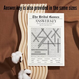 May include: A printable bridal shower game with a word search puzzle. The puzzle features words related to weddings, such as "bride", "groom", "wedding", and "honeymoon". The answer key is provided below the puzzle.