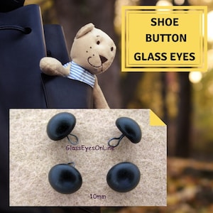 May include: Four black plastic shoe buttons with metal loops. The buttons are 10mm in diameter. The text "GlassEyesOnline" and "10mm" are visible in the image.