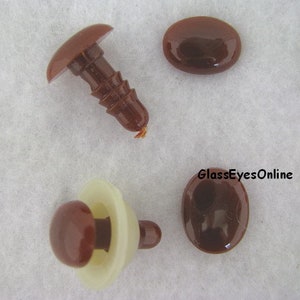 May include: Four brown plastic safety eyes for crafts. Two eyes are flat and two eyes are attached to a plastic post.