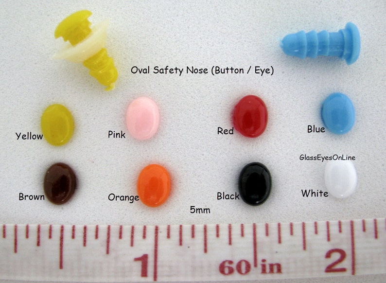May include: Assortment of oval-shaped safety eyes and noses in various colors, including yellow, pink, red, blue, brown, orange, black, and white. The eyes and noses are 5mm in diameter and are shown next to a ruler for size reference. Oval Safety Nose (Button / Eye) GlassEyesOnLine