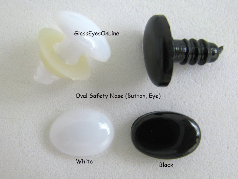 May include: Two oval safety noses for stuffed animals, one white and one black. The noses are made of plastic and have a smooth, shiny finish. GlassEyesOnline.