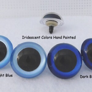 May include: Four plastic eyes for crafts, with black pupils and iridescent blue, light blue, and dark blue colors. The text "Iridescent Colors Hand Painted" is above the eyes. The text "Light Blue" is below the light blue eye. The text "Dark Blue" is below the dark blue eye.