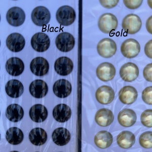 May include: Two sheets of self-adhesive googly eyes. One sheet has black eyes and the other sheet has gold eyes.