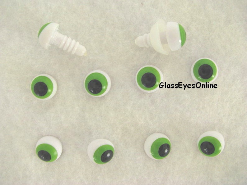 May include: A set of ten green and black plastic safety eyes with white pupils. The eyes are for craft projects and come with two screw-in backs.