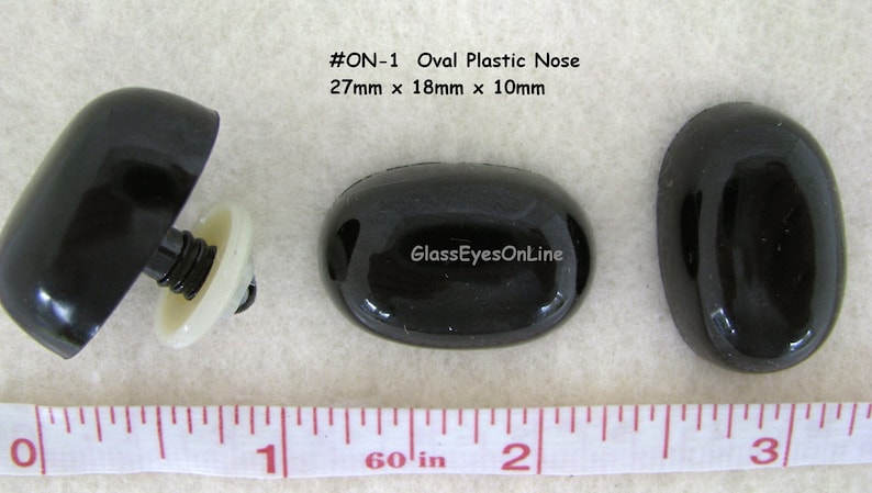 May include: Three black oval plastic noses, one with a white plastic screw-on back. The noses measure 27mm x 18mm x 10mm. The text #ON-1 Oval Plastic Nose 27mm x 18mm x 10mm and GlassEyesOnLine is visible in the image.