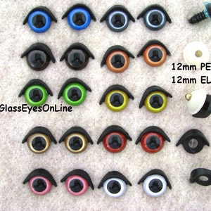 May include: Assortment of 12mm plastic safety eyes in various colors, including blue, black, green, gold, red, pink, and white. The eyes are arranged in rows on a brown fabric background. The text "GlassEyesOnLine" is visible in the lower left corner.  12mm PE-1 and 12mm EL-1 are also visible in the image.