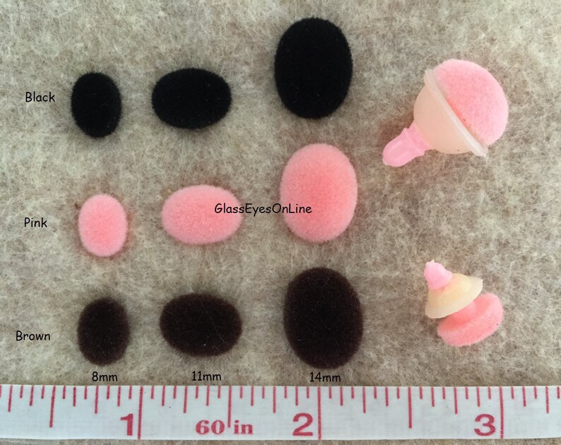 May include: Assortment of black, brown, and pink felt pom-poms in various sizes, measured in inches on a ruler.  The pom-poms are displayed on a beige surface.  The text "GlassEyesOnline" is visible in the image.