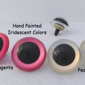 May include: Three pairs of plastic safety eyes for crafts, with black pupils and iridescent hand-painted colors: magenta, pink, and pearl.