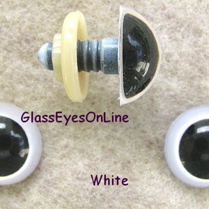 May include: Three black plastic safety eyes with white plastic rims. The eyes are 12mm in diameter. The eyes are on a white background. GlassEyesOnLine and White are written in purple text.