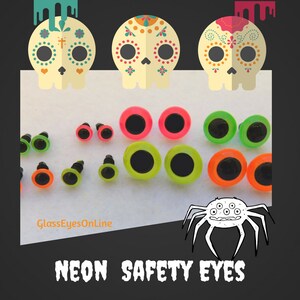 May include: Assortment of neon safety eyes in pink, green, and orange. The eyes are various sizes and have black pupils. The eyes are displayed on a white surface with a spider illustration and the text "GlassEyesOnLine" and "NEON SAFETY EYES".