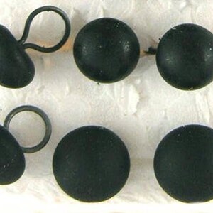 May include: Six black buttons with a loop on the back. The buttons are round and have a smooth surface.