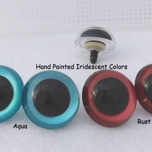 May include: Four pairs of plastic safety eyes for crafts. The eyes are hand painted with iridescent colors: aqua, teal, rust, and red.  The eyes have black pupils.