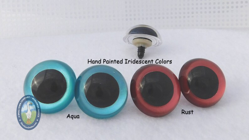 May include: Four pairs of plastic safety eyes for crafts. The eyes are hand painted with iridescent colors: aqua, teal, rust, and red.  The eyes have black pupils.