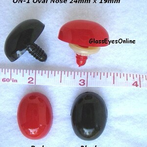 May include: Four plastic oval noses, two black and two red, with a screw-on post. The noses are 24mm x 19mm. The text "ON-1 Oval Nose 24mm x 19mm" and "GlassEyesOnline" are visible in the image.