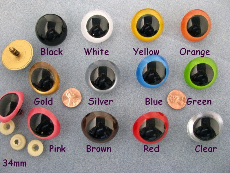 May include: Assortment of 34mm plastic safety eyes in various colours, including black, white, yellow, orange, gold, silver, blue, green, pink, brown, red, and clear. The eyes have a black pupil and a white ring around the pupil.