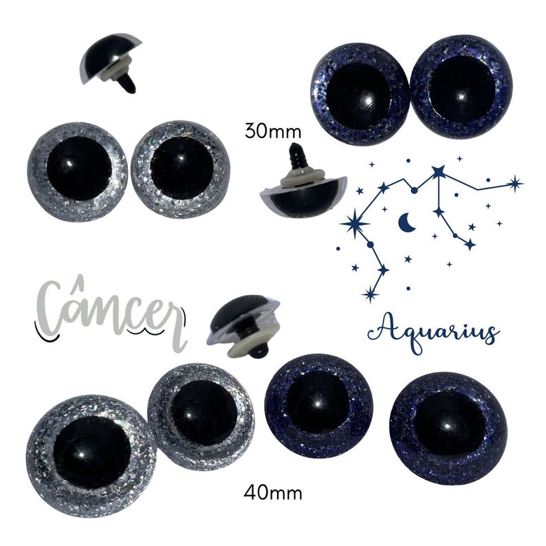 May include: Two pairs of plastic safety eyes with black pupils and silver and blue glitter. The eyes are 30mm and 40mm in diameter. The text "Cancer" and "Aquarius" are written below the eyes.