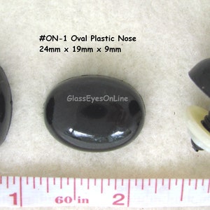 May include: Three black plastic oval-shaped noses with a screw-on back. The noses are 24mm x 19mm x 9mm. #ON-1 Oval Plastic Nose. GlassEyesOnLine.