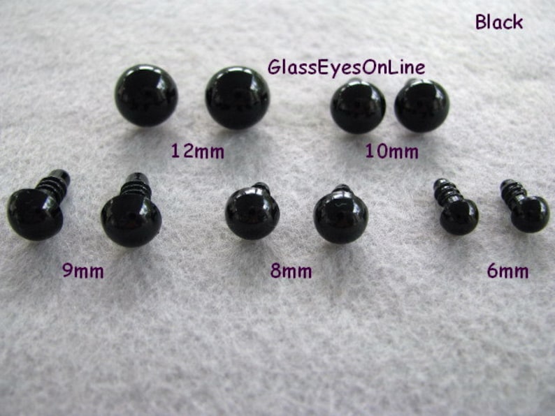 May include: Assortment of black plastic safety eyes for crafts. The eyes come in six sizes: 6mm, 8mm, 9mm, 10mm, 12mm.  The text "GlassEyesOnLine" is printed on the image.