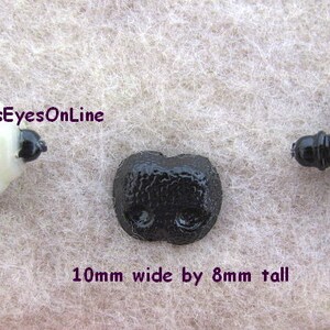 May include: Three black plastic safety eyes with a textured surface. The eyes are 10 mm wide by 8 mm tall.  GlassEyesOnLine.