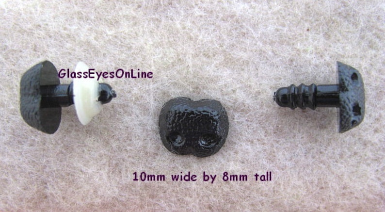 May include: Three black plastic safety eyes with a textured surface. The eyes are 10 mm wide by 8 mm tall.  GlassEyesOnLine.