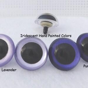 May include: Three pairs of iridescent plastic safety eyes for crafts. The eyes are hand-painted in lavender, light purple, and purple.  The eyes have black pupils.