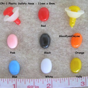 May include: Assortment of plastic safety noses in various colors, including red, pink, black, orange, blue, white, and yellow. The noses are 11mm x 8mm in size. #ON-1 Plastic Safety Nose - 11mm x 8mm