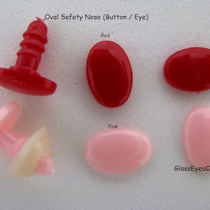 May include: Oval safety nose buttons in red and pink. The buttons have a flat back and a post on the front. The buttons are used for making stuffed animals.