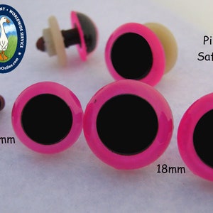 May include: Pink neon safety eyes for crafts, 15mm and 18mm in size.  The eyes have a black pupil and a pink rim.