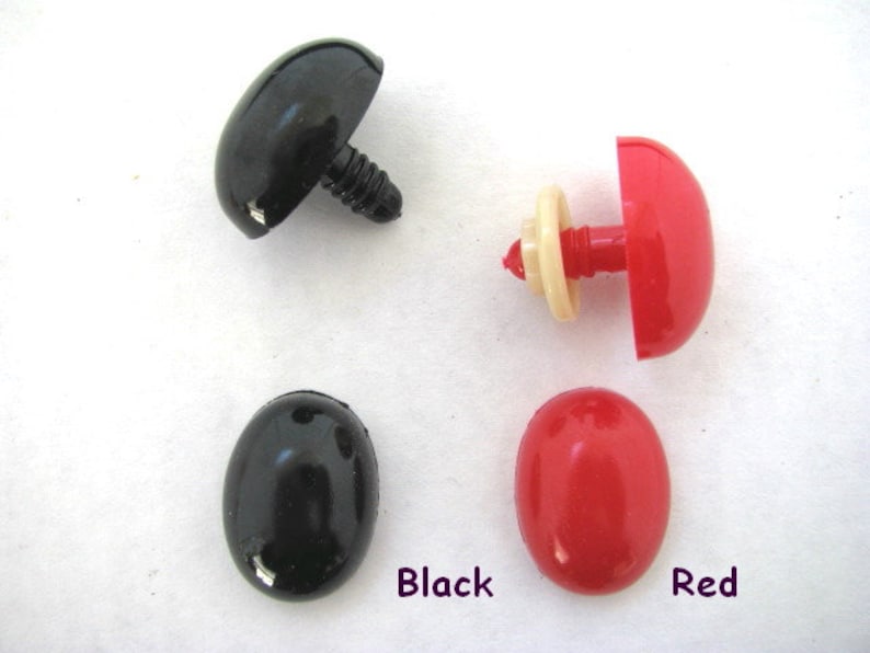 May include: Four plastic safety eyes for crafts. Two black round eyes, one black dome-shaped eye with a screw post, and one red dome-shaped eye with a screw post. The eyes are labeled "Black" and "Red".