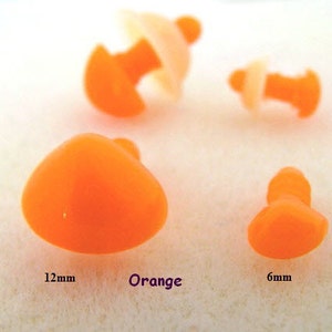 May include: Four orange plastic safety eyes in different sizes. The largest eye is 12mm in diameter, the smallest is 6mm.  The eyes are used for craft projects, such as stuffed animals.