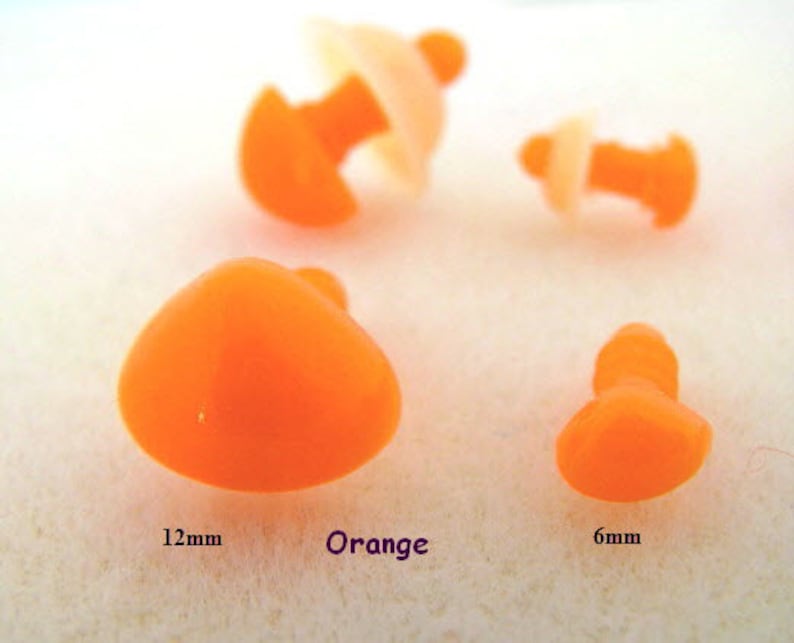 May include: Four orange plastic safety eyes in different sizes. The largest eye is 12mm in diameter, the smallest is 6mm.  The eyes are used for craft projects, such as stuffed animals.