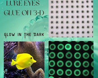 May include: A sheet of glow-in-the-dark 3D lure eyes. The eyes are white with black pupils and are arranged in a grid pattern. The sheet is shown next to a yellow fish swimming in a coral reef. The text "LURE EYES GLUE ON 3-D GLOW IN THE DARK" is visible in the image.