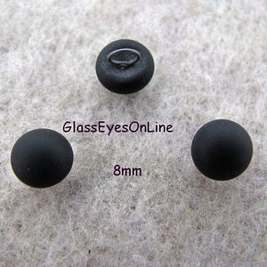 May include: Three black glass eyes with a metal shank for sewing. The eyes are 8mm in diameter.