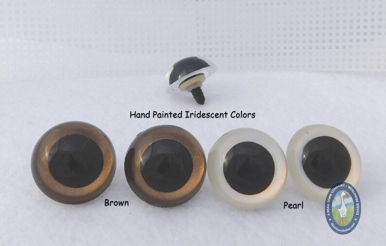 May include: Three plastic safety eyes for crafts, with black pupils and iridescent finishes. The eyes are shown in brown, gold, and pearl colors.  Hand Painted Iridescent Colors. Brown, Pearl.