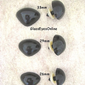 May include: Three black triangle safety noses with a screw-on back. The noses are 33mm, 29mm, and 26mm in size. #TN-1 Triangle Safety Noses GlassEyesOnline