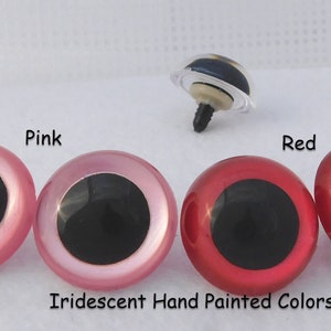 May include: Two pairs of plastic doll eyes, one pair pink and one pair red. The eyes are iridescent and hand painted. The eyes have black pupils.