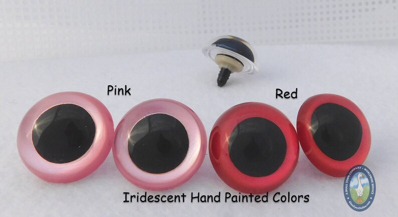 May include: Two pairs of plastic doll eyes, one pair pink and one pair red. The eyes are iridescent and hand painted. The eyes have black pupils.