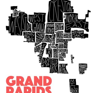 May include: A monochrome map of Grand Rapids, Michigan, featuring handwritten neighbourhood names. The city's name is displayed in large, red letters at the bottom. The map is set against a white backdrop.
