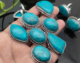 May include: A collection of turquoise gemstone rings with silver-colored settings. The rings feature various shapes, including oval, teardrop, and rectangular designs. The turquoise stones display a distinctive blue-green color with dark veining. The Purified Gems.