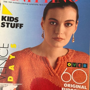 May include: A magazine cover featuring a woman wearing a bright orange knitted sweater. The magazine is titled "Stylish Knitting" and the cover text says "Over 60 Original European Knit Patterns".