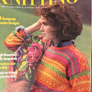 May include: A magazine cover featuring a woman wearing a colorful knitted sweater with a floral design. The magazine is titled "Stylish Knitting" and the cover text says "Top International Knitting Magazine".